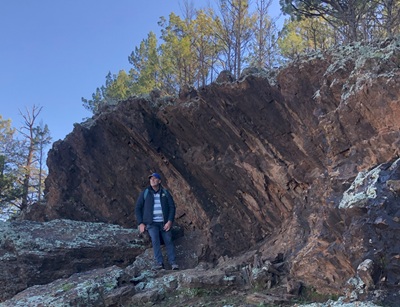 Leo Standing under a rock formation